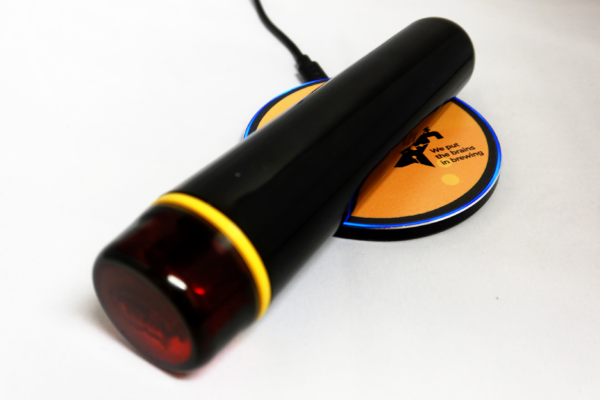 Float Pro digital hydrometer placed on a wireless charging pad
